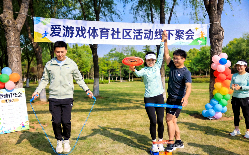 爱游戏体育社区活动线下聚会：参与者在公园完成趣味运动打卡任务，互相鼓励，气氛热烈