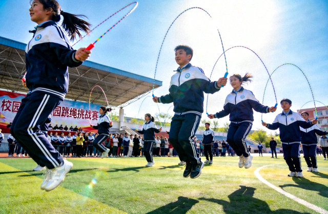 校园跳绳挑战赛中学生们同时起跳的整齐场面
